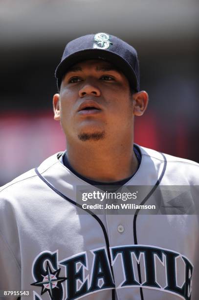 Pitcher Felix Hernandez of the Seattle Mariners looks at the crowd as he walks to the dugout after the third out in the inning during the game...