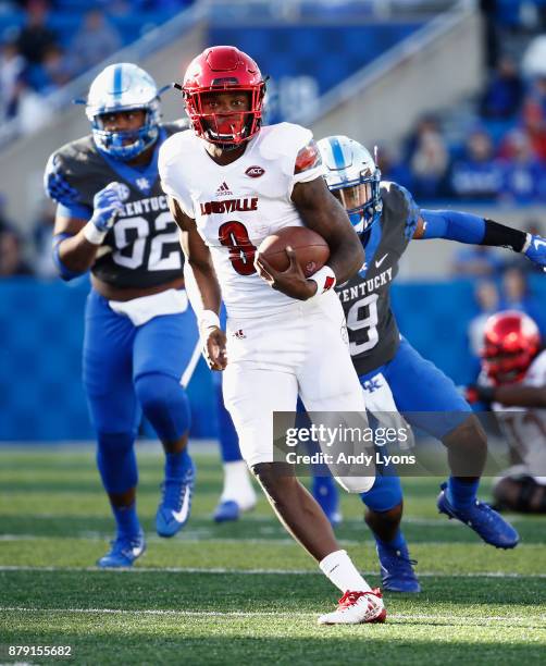 Lamar Jackson of the Louisville Cardinals runs with the ball against the Kentucky Wildcats during the game at Commonwealth Stadium on November 25,...