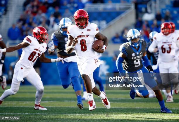 Lamar Jackson of the Louisville Cardinals runs with the ball against the Kentucky Wildcats during the game at Commonwealth Stadium on November 25,...