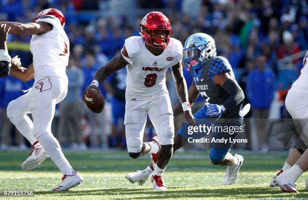 Lamar Jackson of the Louisville Cardinals runs with the ball against the Kentucky Wildcats during the game at Commonwealth Stadium on November 25,...