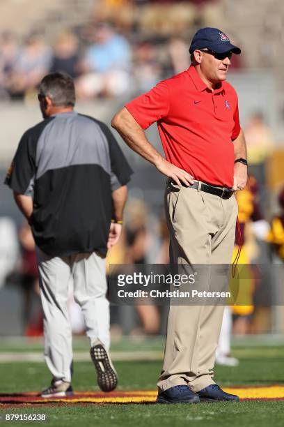 Head coache Rich Rodriguez of the Arizona Wildcats looks on as Todd Graham of the Arizona State Sun Devils walks away before the college football...