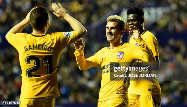 Atletico Madrid's French forward Antoine Griezmann celebrates with Atletico Madrid's French forward Kevin Gameiro after scoring during the Spanish...