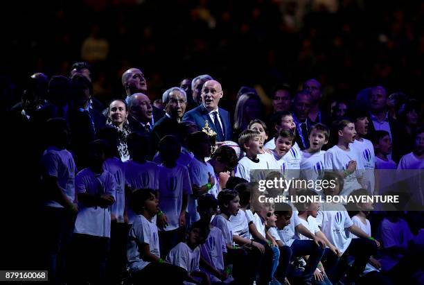 President of French Rugby Federation, Bernard Laporte poses with President of Japanese Rugby Federation Tadashi Okamura and children during the...