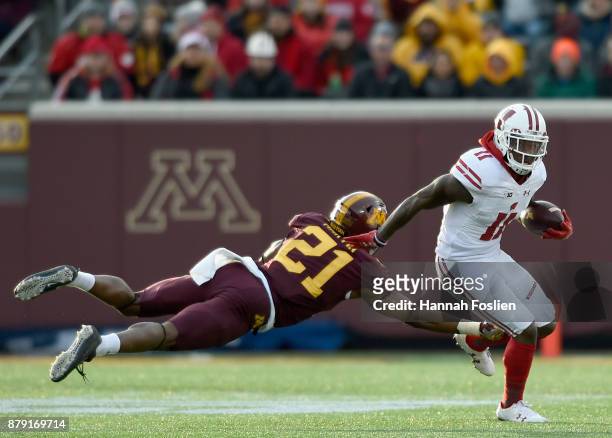 Kamal Martin of the Minnesota Golden Gophers tackles Jazz Peavy of the Wisconsin Badgers on a punt return during the second quarter of the game on...