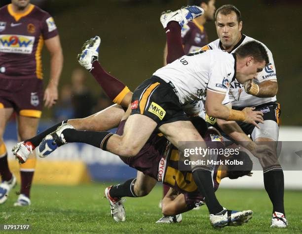 Ben Te'o of the Broncos is flipped in a tackle during the round 11 NRL match between the Wests Tigers and the Brisbane Broncos at Campbelltown Sports...