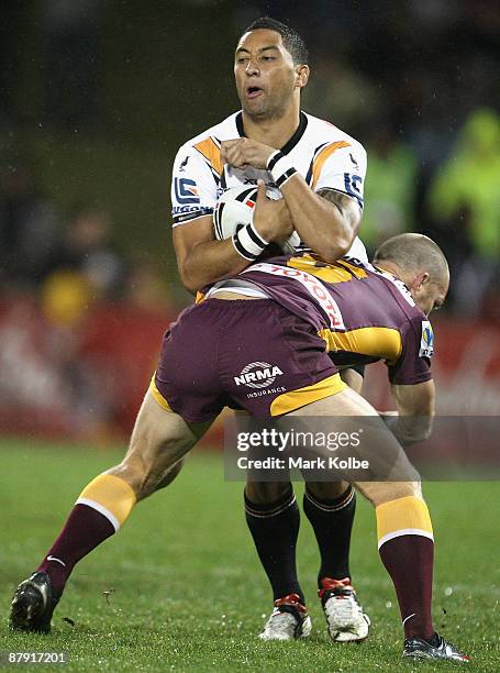 Benji Marshall of the Tigers is tackled during the round 11 NRL match between the Wests Tigers and the Brisbane Broncos at Campbelltown Sports...