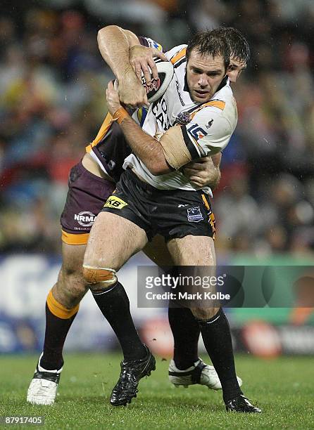 John Skandalis of the Tigers is tackled during the round 11 NRL match between the Wests Tigers and the Brisbane Broncos at Campbelltown Sports...