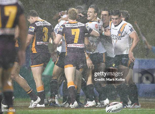 The Tigers celebrate after a try which was later disallowed by the video referee during the round 11 NRL match between the Wests Tigers and the...