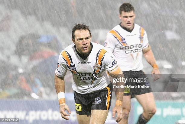 John Skandalis of the Tigers looks for a hit up in the driving rain during the round 11 NRL match between the Wests Tigers and the Brisbane Broncos...