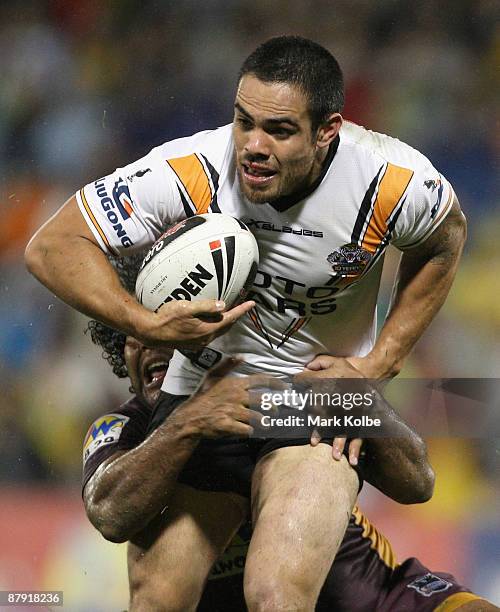 Dene Halatau of the Tigers is tackled during the round 11 NRL match between the Wests Tigers and the Brisbane Broncos at Campbelltown Sports Stadium...