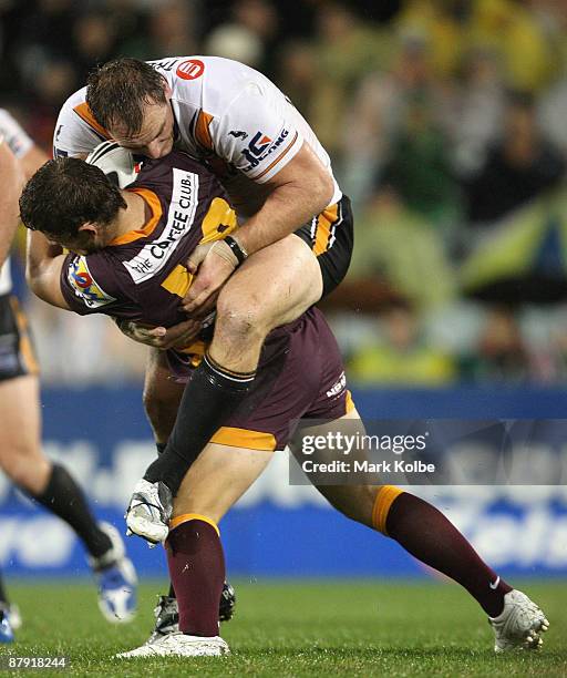 Gareth Ellis of the Tigers tackles Aaron Gorrell of the Broncos during the round 11 NRL match between the Wests Tigers and the Brisbane Broncos at...