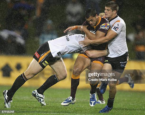 Karmichael Hunt of the Broncos is hit by heavy Tigers defence during the round 11 NRL match between the Wests Tigers and the Brisbane Broncos at...