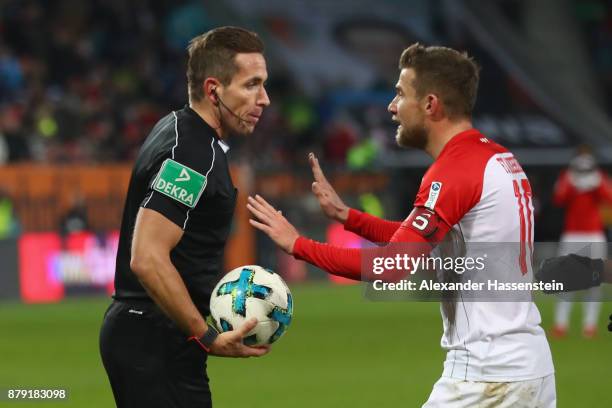 Referee Tobias Stieler reacts with Daniel Baier of Augsburg during the Bundesliga match between FC Augsburg and VfL Wolfsburg at WWK-Arena on...