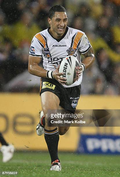 Benji Marshall of the Tigers runs the ball up during the round 11 NRL match between the Wests Tigers and the Brisbane Broncos at Campbelltown Sports...