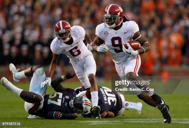 Bo Scarbrough of the Alabama Crimson Tide rushes the ball during the third quarter against the Auburn Tigers at Jordan Hare Stadium on November 25,...