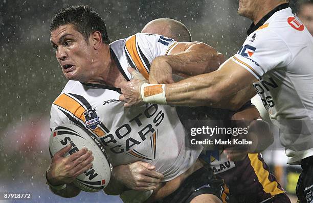 Chris Heighington of the Tigers is tackled during the round 11 NRL match between the Wests Tigers and the Brisbane Broncos at Campbelltown Sports...