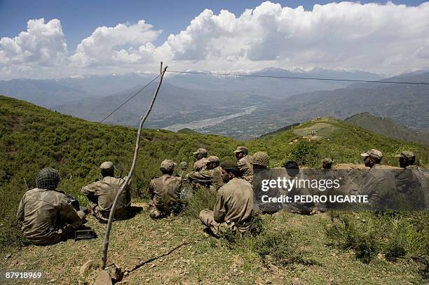 Pakistani soldiers sit on top of a mountain at Banai Baba Ziarat area in northwest Pakistan on May 22, 2009. The army took control of the mountain...