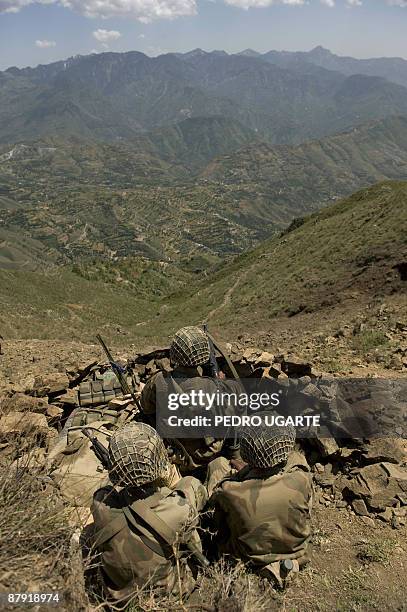 Pakistani soldiers sit on top of a mountain at Banai Baba Ziarat area in northwest Pakistan on May 22, 2009. The army took control of the mountain...