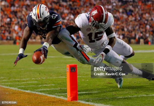 Kerryon Johnson of the Auburn Tigers is hit by Ronnie Harrison of the Alabama Crimson Tide diving towards the endzone during the third quarter of...