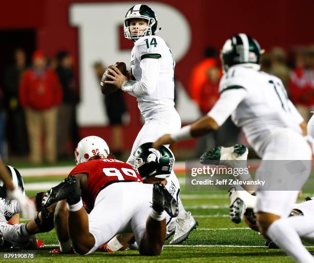 Brian Lewerke of the Michigan State Spartans looks to pass against the Rutgers Scarlet Knights during their game on November 25, 2017 in Piscataway,...