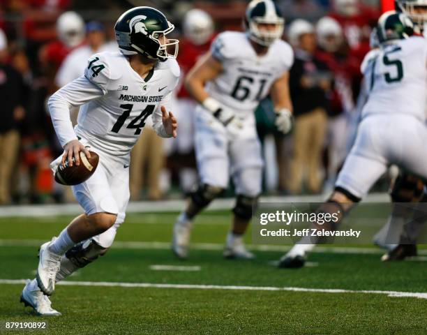 Brian Lewerke of the Michigan State Spartans rolls out against the Rutgers Scarlet Knights during their game on November 25, 2017 in Piscataway, New...