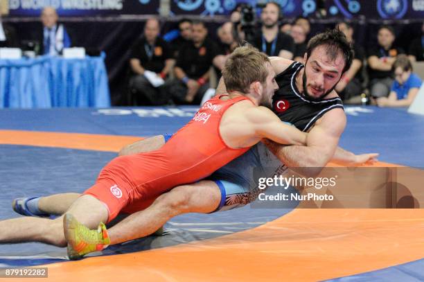 Moldovas Mihail Esanu competes with Turkeys Sedat Ozdemir during the Senior U23 Wrestling World Championships in the 61 kg class on November 25, 2017...