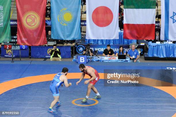 Russias Magomedamin Dibiro competes with Georgias Geno Petriashvili during the Senior U23 Wrestling World Championships in the 125 kg class on...