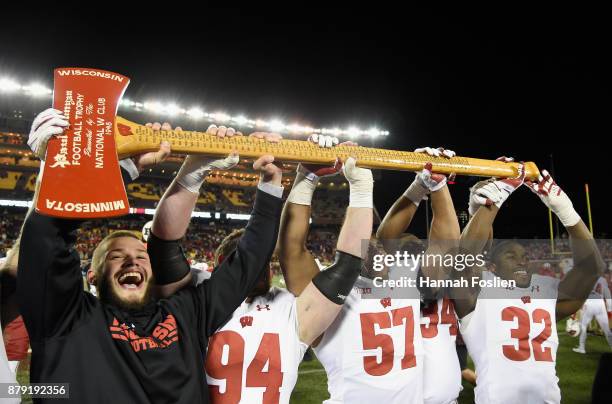 The Wisconsin Badgers hoist Paul Bunyan's Axe after winning the game against the Minnesota Golden Gophers on November 25, 2017 at TCF Bank Stadium in...