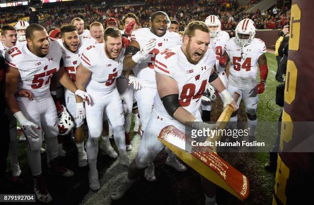 Conor Sheehy of the Wisconsin Badgers celebrates with Paul Bunyan's Axe after winning the game against the Minnesota Golden Gophers on November 25,...