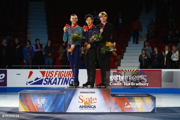 Silver medalist Adam Rippon of the United States, gold medalist Nathan Chen of the United States, and bronze medalist Sergei Voronov of Russia, pose...