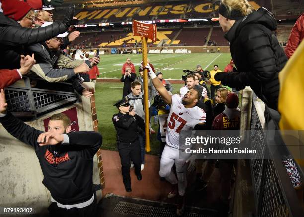 Alec James of the Wisconsin Badgers celebrates with Paul Bunyan's Axe after winning the game against the Minnesota Golden Gophers on November 25,...