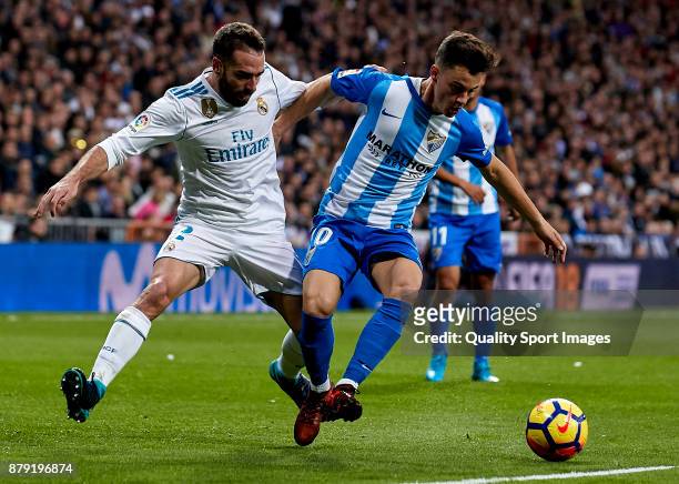 Daniel Carvajal of Real Madrid competes for the ball with Juan Pablo Anor 'Juanpi' of Malaga CF during the La Liga match between Real Madrid and...