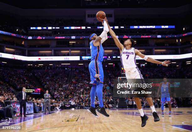 Carmelo Anthony of the Oklahoma City Thunder shoots over Skal Labissiere of the Sacramento Kings at Golden 1 Center on November 7, 2017 in...