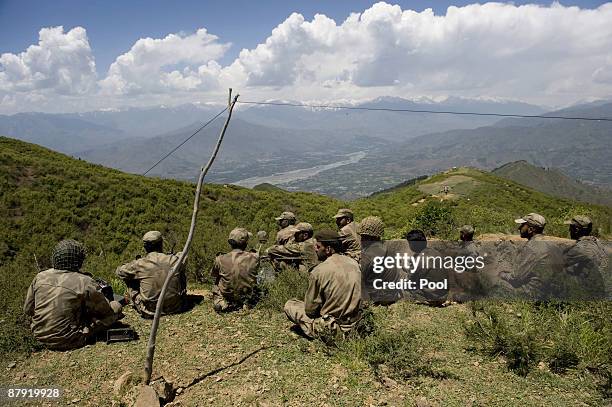 Pakistani soldiers seat on top of a mountain at Banai Baba Ziarat area on May 22, 2009 in northwest Pakistan. Troops took control of the mountain...