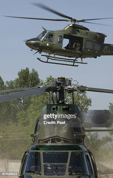 Military helicopter lands in Khwazakhela base helicopter lands at Pakistani soldiers take cover as an helicopter takes off from the top of a mountain...