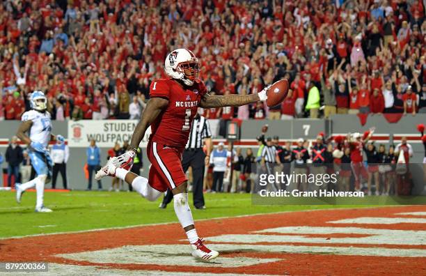Jaylen Samuels of the North Carolina State Wolfpack scores the game-clinching touchdown late in the fourth quarter of their game against the North...