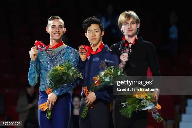 Silver medalist Adam Rippon of the United States, gold medalist Nathan Chen of the United States, and bronze medalist Sergei Voronov of Russia, pose...