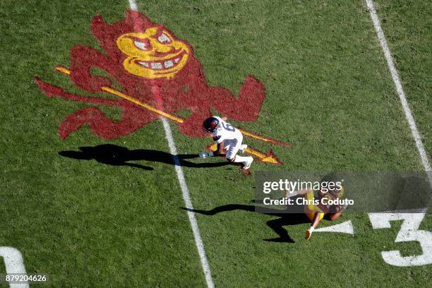 Wide receiver Shun Brown of the Arizona Wildcats slips past defensive back Chad Adams of the Arizona State Sun Devils during the first half of the...