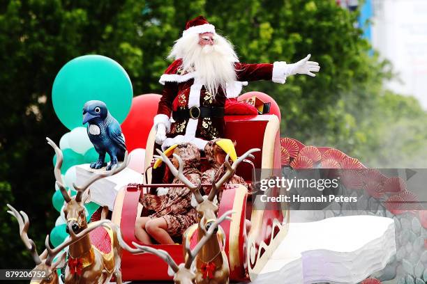 Santa waves to the crowds during the annual Farmers Santa Parade on November 26, 2017 in Auckland, New Zealand. The Farmers Santa Parade has brought...