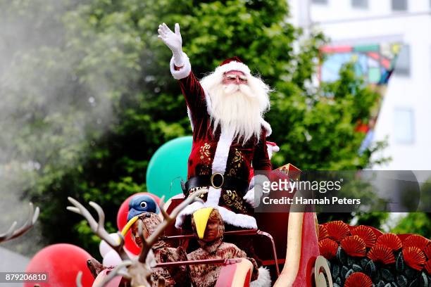 Santa waves to the crowds during the annual Farmers Santa Parade on November 26, 2017 in Auckland, New Zealand. The Farmers Santa Parade has brought...