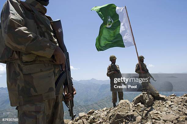 Pakistani soldiers stand guard on top of a mountain overlooking the Swat valley on May 22, 2009 in theBanai Baba Ziarat area of northwest Pakistan....