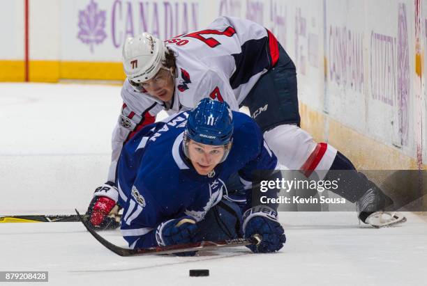 Zach Hyman of the Toronto Maple Leafs keeps his eye on the puck with T.J. Oshie of the Washington Capitals during the second period at the Air Canada...