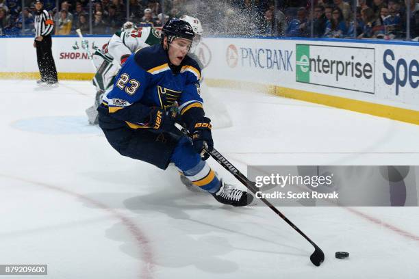 Dmitrij Jaskin of the St. Louis Blues controls the puck as Kyle Quincey of the Minnesota Wild defends at Scottrade Center on November 25, 2017 in St....
