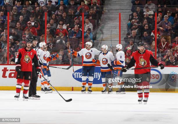 Jordan Eberle of the New York Islanders celebrates his third period goal with teammates including Andrew Ladd and Nick Leddy as Erik Karlsson and...