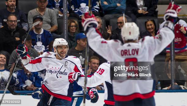 Alex Ovechkin of the Washington Capitals celebrates his third goal of the game against the Toronto Maple Leafs with teammates Nicklas Backstrom and...