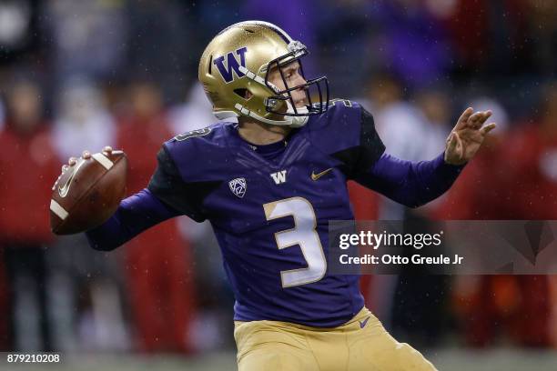 Quarterback Jake Browning of the Washington Huskies passes against the Washington State Cougars at Husky Stadium on November 25, 2017 in Seattle,...