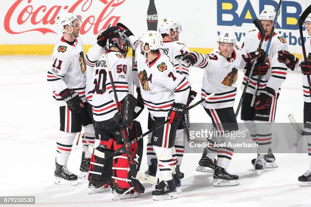 Teammates congratulate goaltender Corey Crawford of the Chicago Blackhawks after the game against the Florida Panthers at the BB&T Center on November...