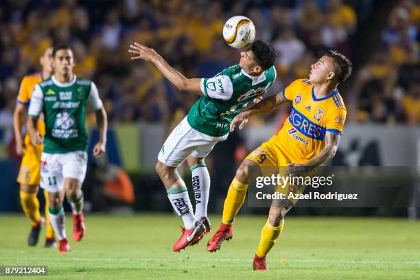 Alvaro Ramos of Leon heads the ball with observed by Eduardo Vargas of Tigres during the quarter finals second leg match between Tigres UANL and Leon...