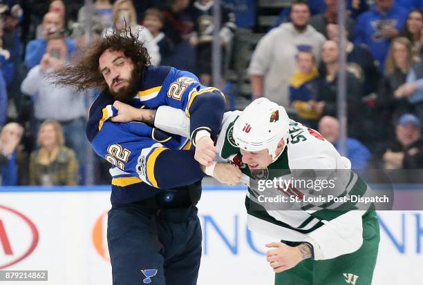 The St. Louis Blues' Chris Thorburn, left, fights with the Minnesota Wild's Chris Stewart in the first period on Saturday, Nov. 25 at the Scottrade...