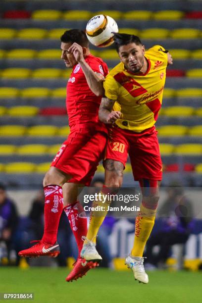 Osvaldo Gonzalez of Toluca and Rodrigo Millar of Morelia jum for the ball during the quarter finals second leg match between Morelia and Toluca as...